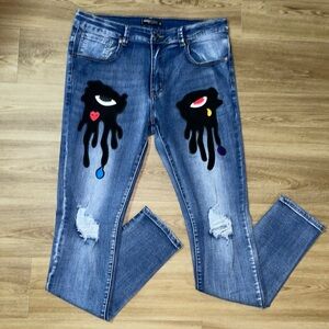 Blue jeans with embroidered patches
